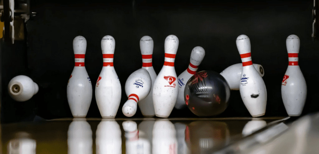 bowling ball hitting pins to strike with proper entry angle and speed with deflection